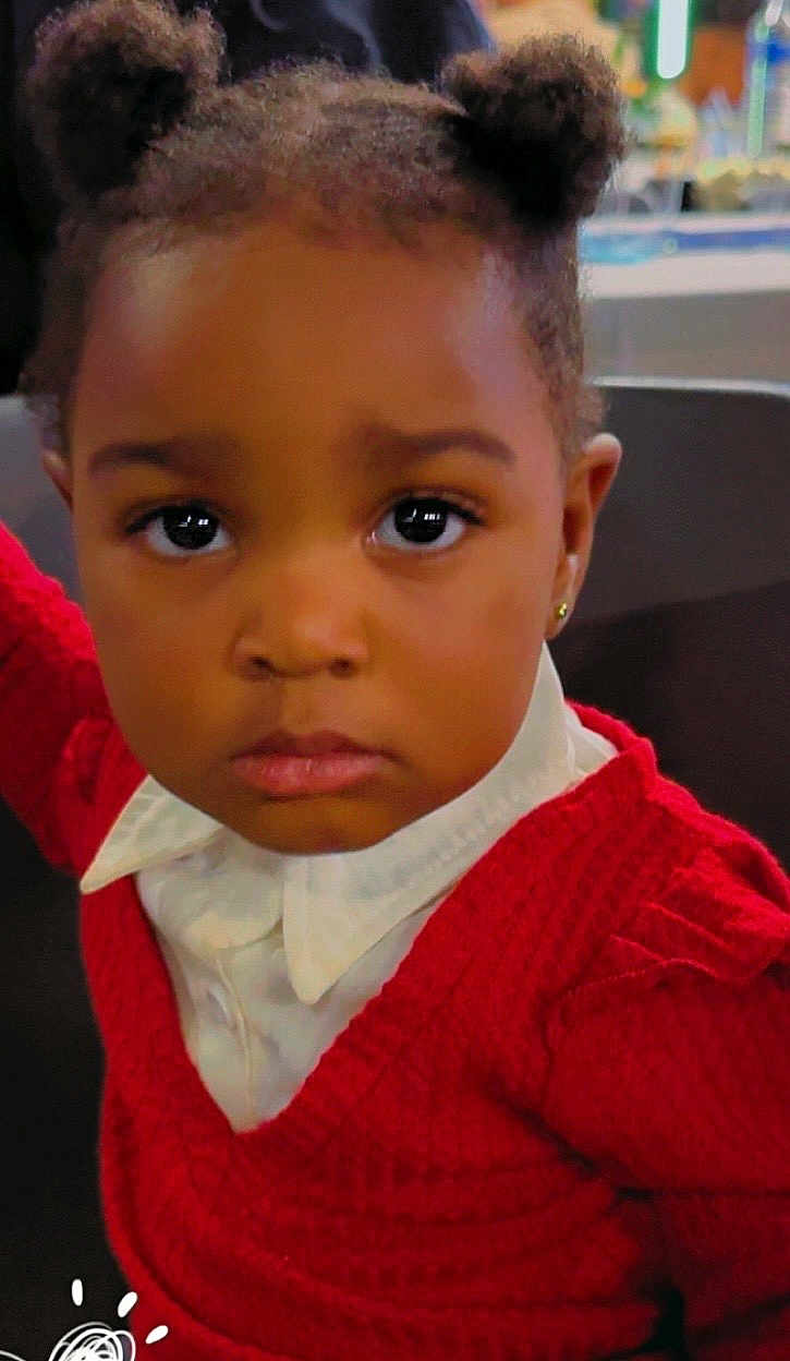 Janaya participe au concours pour gagner de l'argent avec cette photo : toddler, child, portrait, face, expression, curly_hair, red_sweater, white_shirt, indoor, person, cute, young_child, hairstyle, pigtails, looking_at_camera, skin_tone, earrings, serious_face, closeup, fashion