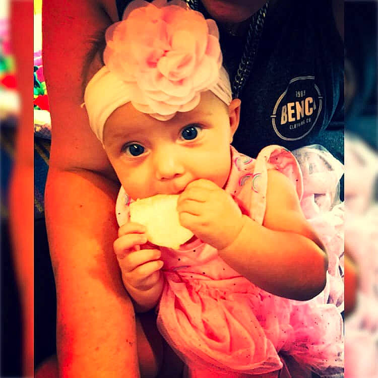 Lyric Maddison Marie Lynn is registered to the contest to win money with this photo: arm, baby, baby_toddler_clothing, cheek, child, finger, flower, gesture, hand, happy, hat, headgear, headwear, lip, mouth, nail, person, pink, plant, skin