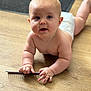 baby, child, diaper, floor, wooden_floor, crawling, blue_eyes, curious, hands, skin, infant, indoor, person, young_child, portrait, cute, chubby, naked_torso, one_person, holding_object