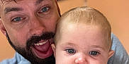 Bryana participe au concours pour gagner de l'argent avec cette photo : baby, background_blur, beard, blue_eyes, cartoon_print, casual, child, closeup, expression, face, family, holding, indoor, man, person, picture_frame, portrait, purple_clothing, smile, tattoo