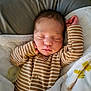 baby, newborn, sleeping, blanket, pacifier, onesie, striped_clothing, infant, cute, peaceful, resting, soft_texture, bed, cozy, small_hands, closed_eyes, portrait, indoor, child, face
