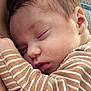 baby, sleeping, closeup, face, infant, newborn, skin, hair, striped_clothing, comfort, rest, peaceful, soft_texture, portrait, child, human, cuteness, nap, cozy, young