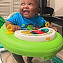 Legend joined the competition — help win amazing prizes! baby, child, indoor, walker, toy, blue_shirt, smile, happy, feet, floor, furniture, table, plastic, play, infant, cute, person, bright_colors, expression, closeup