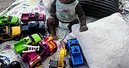 Legend joined the competition — help win amazing prizes! baby, blanket, carpet, child, clothing, colorful, cute, floor, happy, indoor, infant, pillow, play, playtime, plush, room, sitting, smile, toy_cars, young_child