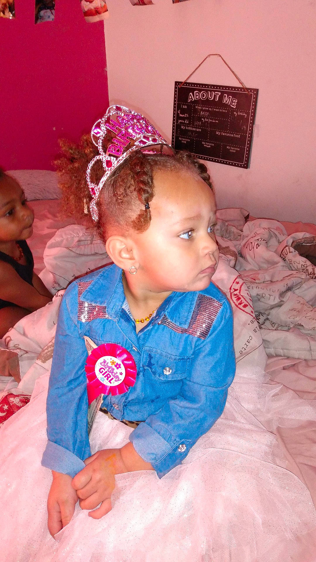 Promise is registered to the contest to win money with this photo: baby, baby_toddler_clothing, child, comfort, costume_hat, event, fun, happy, headband, headpiece, linens, magenta, party_supply, pattern, person, pink, room, sitting, sleeve, textile