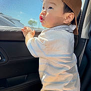 Jayce joined the competition — help win amazing prizes! toddler, child, cap, brown_cap, car_interior, window, mesh_screen, sunlight, shadow, curious, standing, white_shirt, striped_shirt, young_child, side_profile, cute, expression, hand_on_window, casual_clothing, daylight