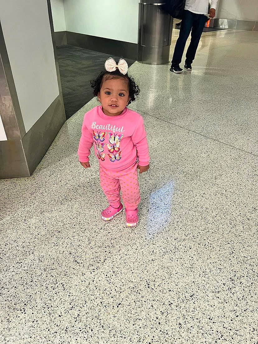 Myraya is registered to the contest to win money with this photo: baby, baby_toddler_clothing, carpet, child, door, floor, flooring, fun, hat, head, human_leg, leg, magenta, person, shoe, sleeve, sneakers, standing, toddler, walking