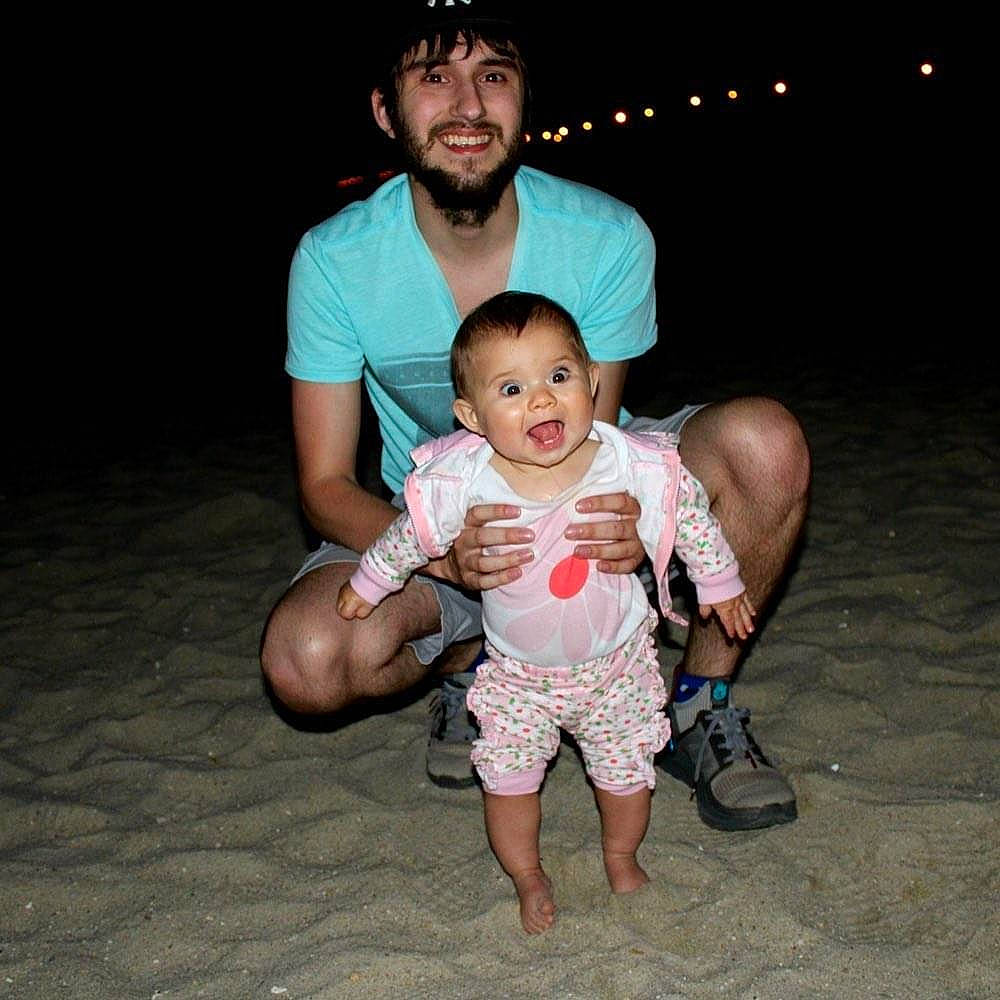 Madelyn is registered to the contest to win money with this photo: arm, baby, barefoot, child, cool, family, fun, happy, joy, leg, muscle, people, person, photography, sitting, smile, t_shirt, toddler, vacation