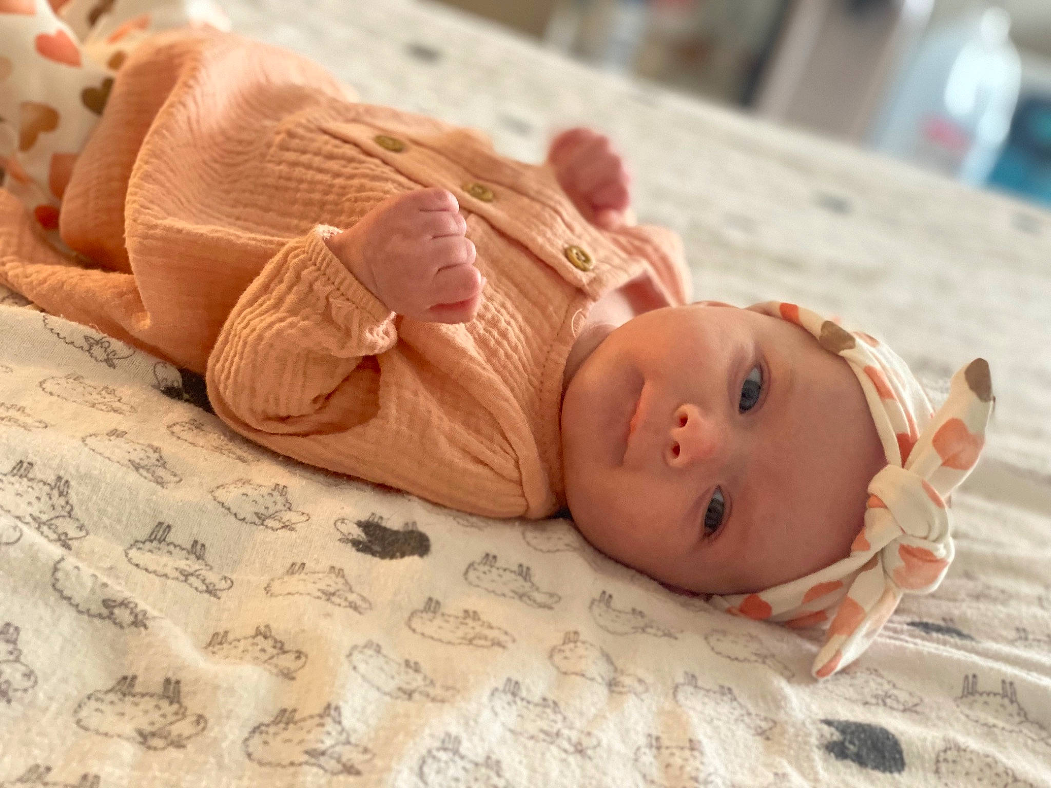 Ellamae joined the competition — help win amazing prizes! baby, baby_toddler_clothing, bedding, child, comfort, eye, fashion_accessory, fawn, flooring, foot, headwear, human_leg, linens, mammal, nose, peach, person, sitting, skin, textile