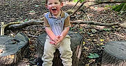 Cole is registered to the contest to win money with this photo: boy, child, clothing, face, grove, head, land, male, nature, outdoors, pants, person, photography, plant, portrait, soil, tree, treestump, vegetation, woodland