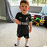 Cole is registered to the contest to win money with this photo: boy, child, clothing, couch, face, footwear, furniture, head, hosiery, male, pants, person, photography, portrait, shoe, shorts, sneaker, sock, standing, t_shirt
