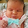 Ryleiah is registered to the contest to win money with this photo: baby, bow, chubby, closeup, cute, face, hair, hand, indoors, infant, newborn, pattern, peaceful, pillow, pink_clothing, portrait, resting, skin, sleeping, soft_focus