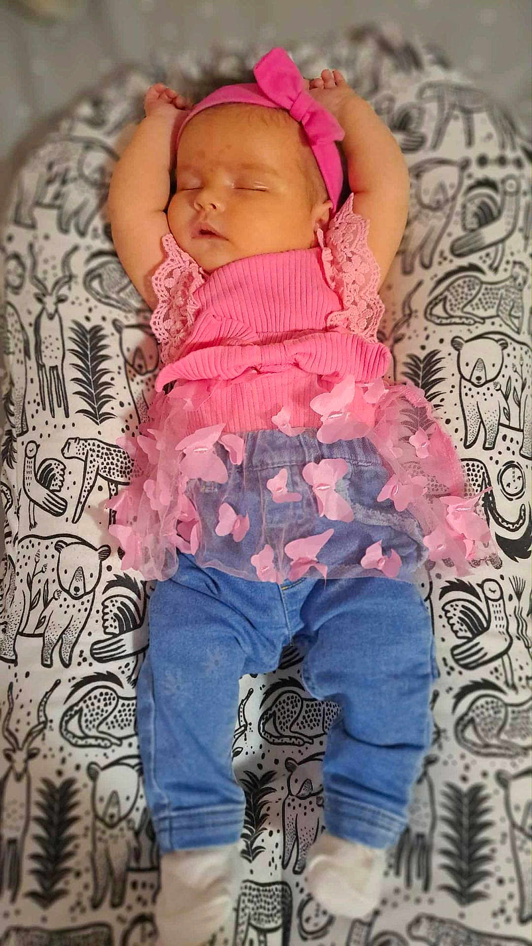 Ryleiah is registered to the contest to win money with this photo: animal_pattern, baby, blanket, blue_pants, child, cute, face, hands_up, headband, home, infant, lying_down, peaceful, pink_clothing, portrait, resting, sleeping, soft_toys, toddler, white_socks