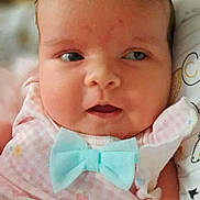 Ryleiah is registered to the contest to win money with this photo: adorable, baby, blue_bow, child, closeup, cute, expression, eyes, face, hair, head, indoors, infant, newborn, person, pink_clothing, portrait, skin, soft_light, young