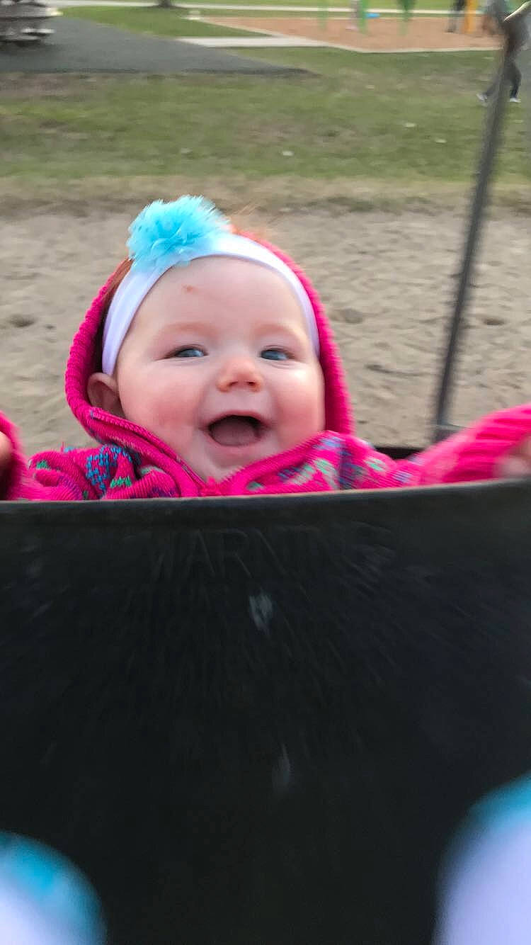 Aubree joined the competition — help win amazing prizes! baby, baby_products, cheek, child, face, facial_expression, fun, grass, happy, head, headgear, outdoor_play_equipment, person, pink, play, playground, product, skin, smile, swing