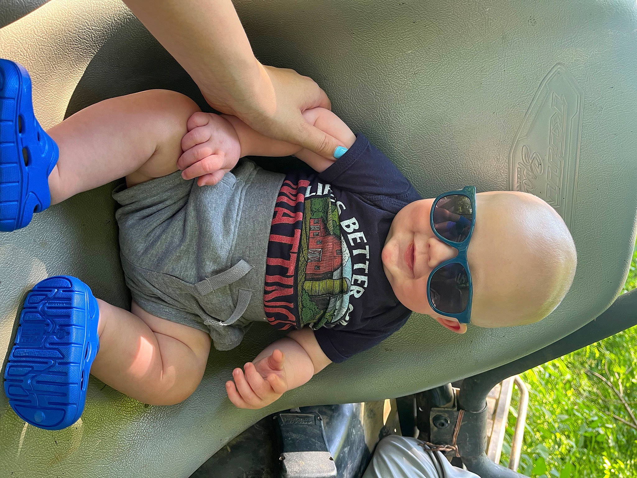 Easton is registered to the contest to win money with this photo: black_hair, blue, chest, child, cool, elbow, eyewear, finger, fun, gesture, hand, headgear, joint, knee, mouth, person, thigh, toddler, trunk, waist
