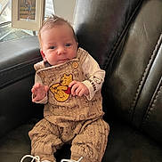 Bentley joined the competition — help win amazing prizes! baby, infant, winnie_the_pooh, clothing, shoes, sitting, chair, leather, portrait, indoors, framed_photo, table, curly_hair, cute, child, person, home, cozy, looking_at_camera, small_hands