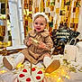 baby, balloon, cake, candle, celebration, child, dress, festive, floor, golden_decorations, happy, indoor, lights, party, person, smiling, socks, star_lights, toy, white_background