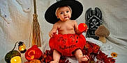 Eden a rejoint le concours — aidez-le/la à gagner de superbes lots ! autumn, baby, candle, celebration, child, costume, cute, decorations, festive, gourds, halloween, holiday, indoor, lantern, leaves, orange, portrait, pumpkin, seasonal, witch_hat