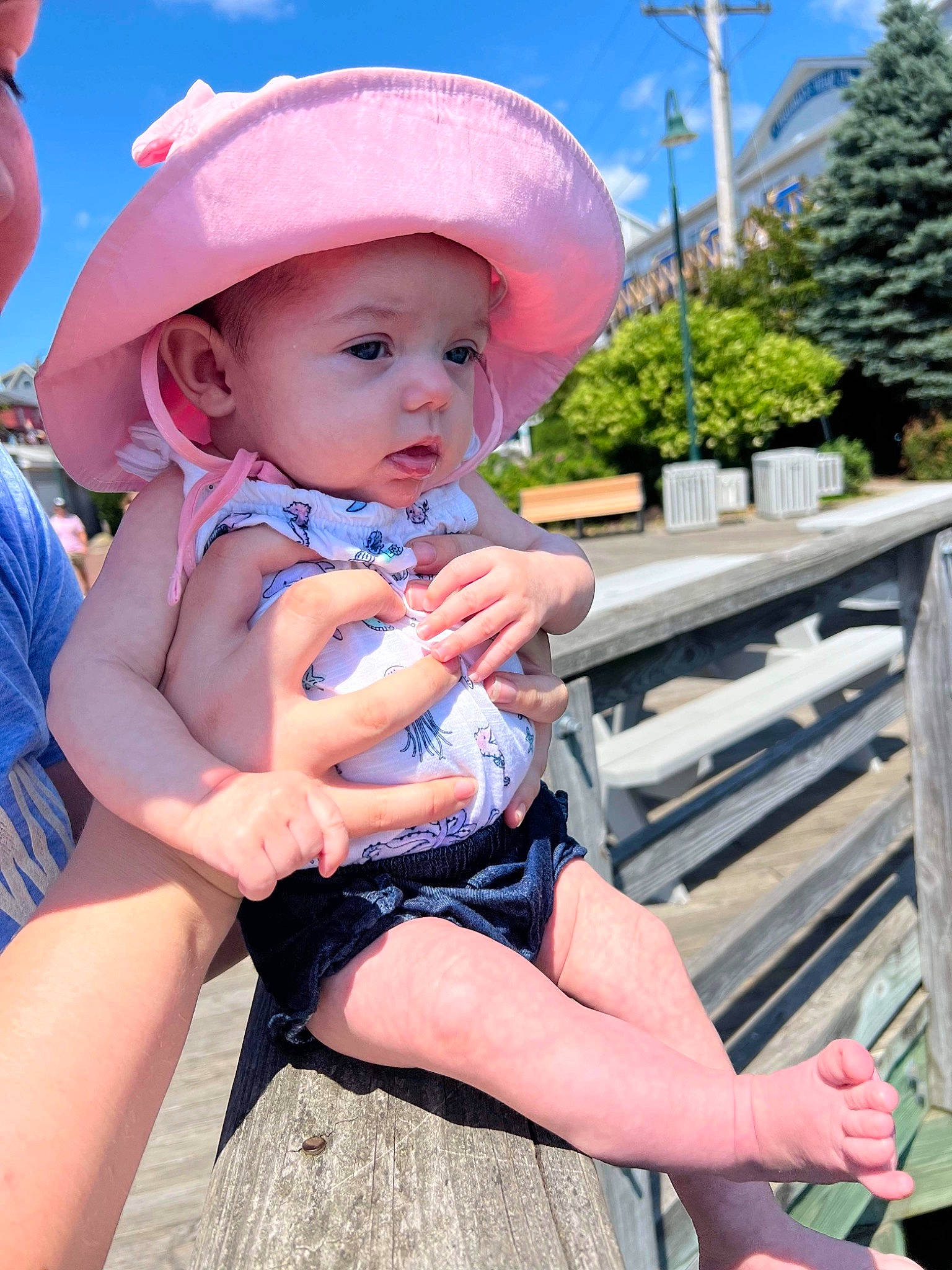 Harlow is registered to the contest to win money with this photo: baby, baby_toddler_clothing, blue, electric_blue, facial_expression, grass, hairstyle, happy, hat, headwear, leisure, person, pink, plant, recreation, skin, sky, summer, sun_hat, thigh