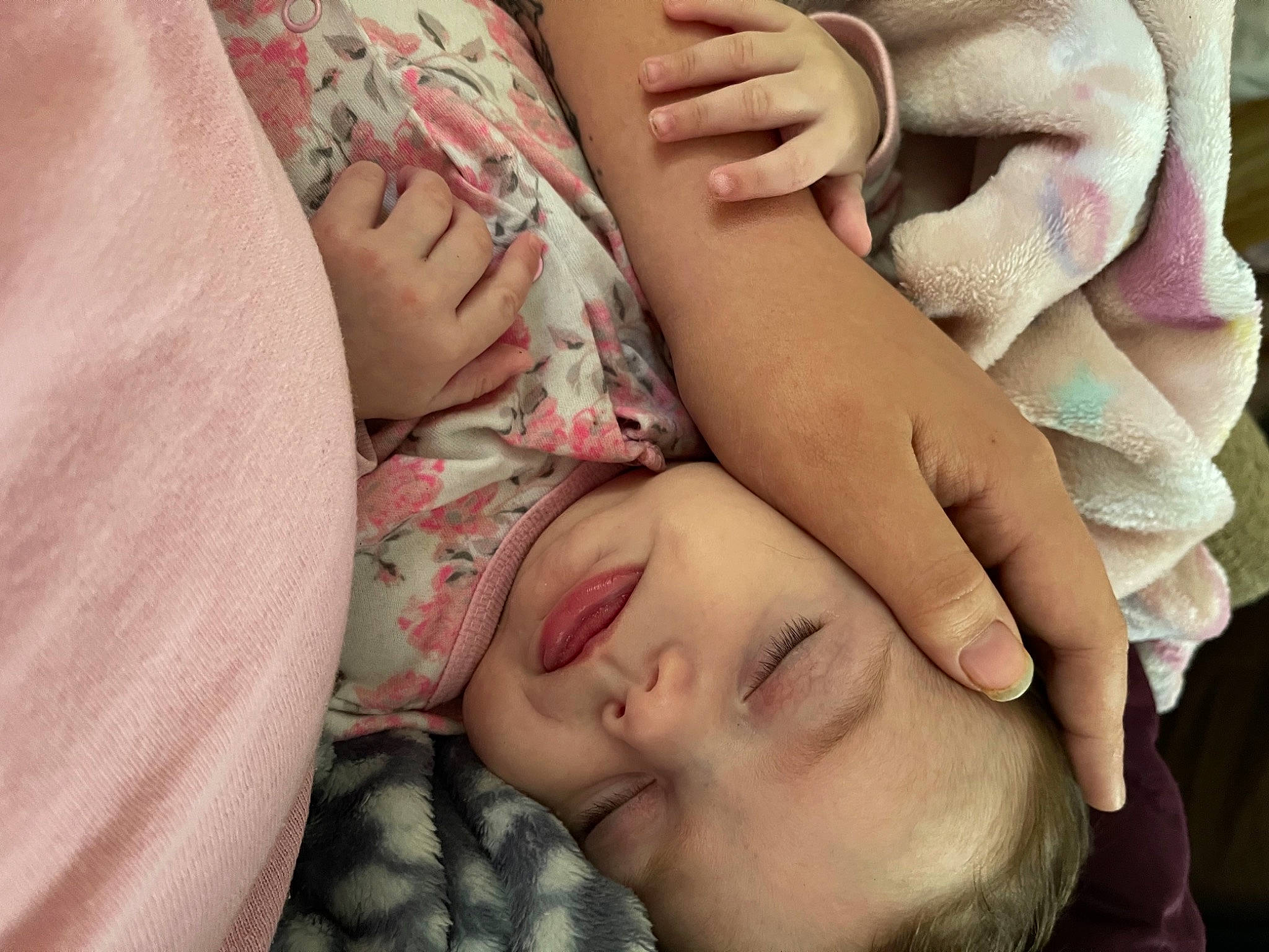 Harlow is registered to the contest to win money with this photo: baby, cheek, child, close_up, comfort, eyelash, facial_expression, finger, gesture, happy, mouth, nail, nose, pattern, person, pink, skin, textile, thumb, toddler