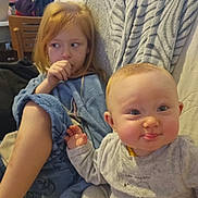 Octavia participe au concours pour gagner de l'argent avec cette photo : baby, blanket, child, couch, cozy, curious, cute, expression, family, furniture, home, indoor, pajamas, playful, portrait, redhead, relaxed, sitting, smiling, toddler