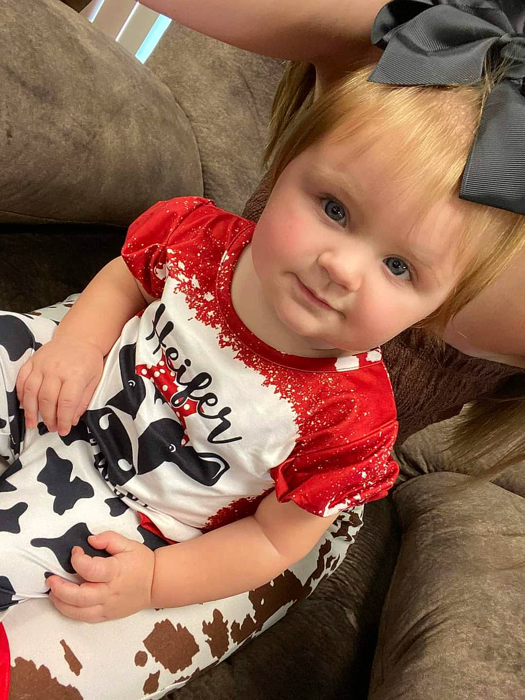 Riverlynn is registered to the contest to win money with this photo: baby, baby_toddler_clothing, brown_hair, carmine, child, comfort, cool, elbow, finger, fun, happy, human_leg, lap, lip, neck, person, sitting, sleeve, t_shirt, thigh