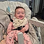 Kim a rejoint le concours — aidez-le/la à gagner de superbes lots ! baby, child, smile, high_chair, bib, pajamas, pink_clothing, indoor, happy, face, infant, seat, wooden_floor, toy, blanket, home, comfort, person, cute, safety_belt