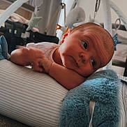 Albie joined the competition — help win amazing prizes! baby, infant, pillow, plush, star, toy, baby_gym, face, head, hand, carpet, striped, soft, resting, indoors, curious, child, floor, room, cozy