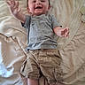 Christopher joined the competition — help win amazing prizes! baby, child, smiling, happy, tshirt, shorts, bed, blanket, towel, person, infant, candid, indoors, cute, young, reaching, lying_down, casual_clothing, comfortable, portrait