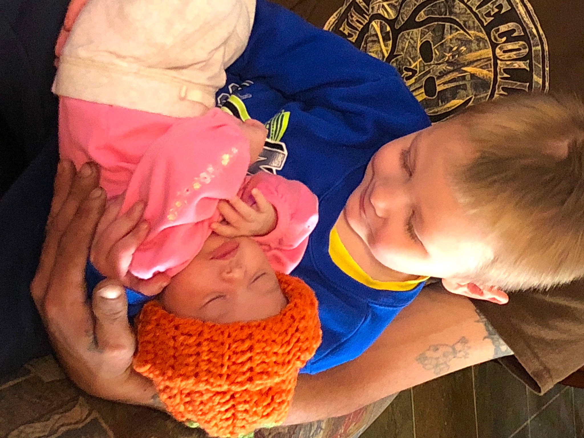 Elijah is registered to the contest to win money with this photo: arm, baby, baby_toddler_clothing, child, finger, fun, happy, headwear, human, mammal, mouth, neck, nose, orange, organ, person, sleeve, textile, thigh, toddler