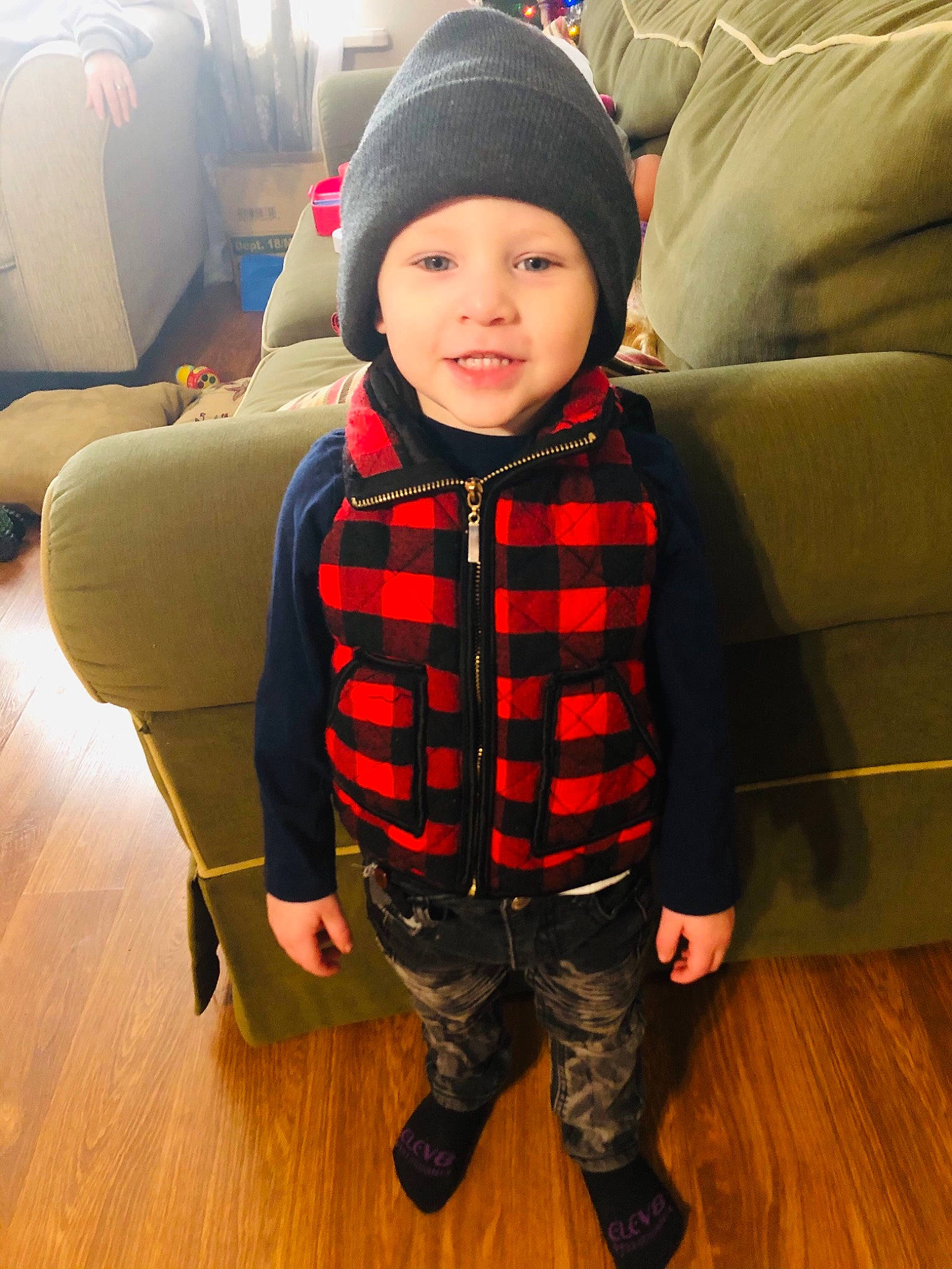 Elijah joined the competition — help win amazing prizes! baby, baby_toddler_clothing, cap, child, comfort, couch, face, flooring, hardwood, headwear, jacket, laminate_flooring, outerwear, person, personal_protective_equipment, plaid, sitting, sleeve, t_shirt, toddler
