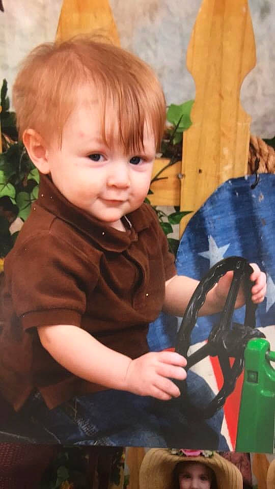 Elijah is registered to the contest to win money with this photo: baby, baby_toddler_clothing, cheek, child, finger, fun, grass, hairstyle, happy, organ, people_in_nature, person, plant, play, product, sitting, standing, toddler, tree, wheel