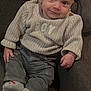 Naël a rejoint le concours — aidez-le/la à gagner de superbes lots ! baby, child, infant, sweater, pants, socks, couch, blanket, clothing, tag, indoor, portrait, smile, cute, young_child, seated, fabric, knitwear, comfortable, fashion