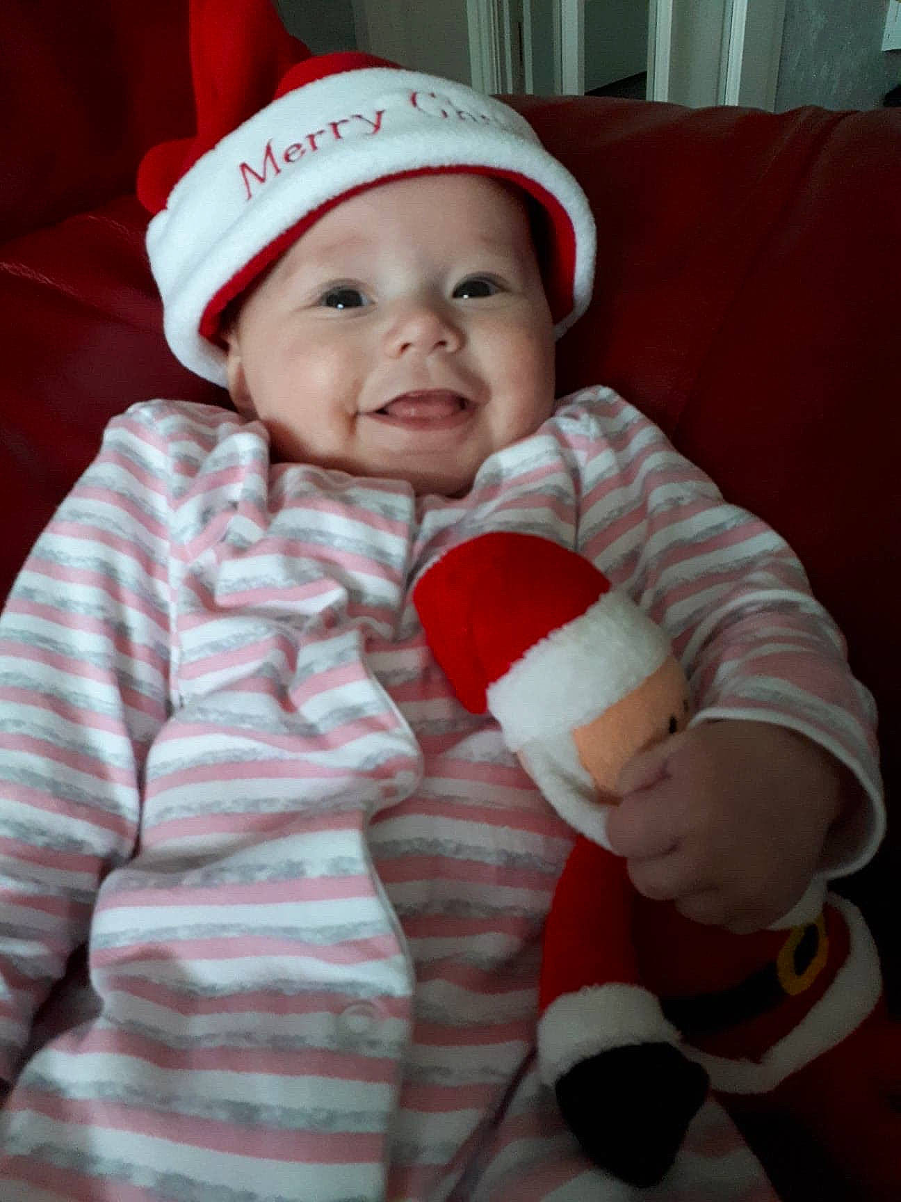 Hayleigh is registered to the contest to win money with this photo: baby, child, christmas, christmas_eve, fictional_character, headwear, person, smile, toddler