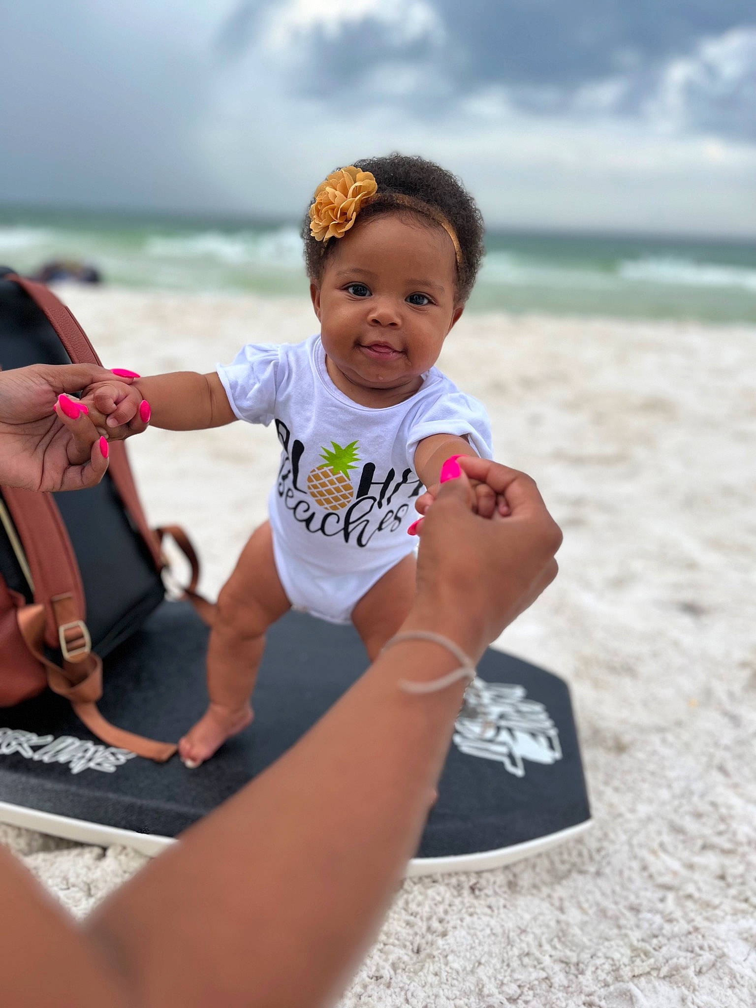 Kolbee is registered to the contest to win money with this photo: barefoot, beach, boats_and_boating_equipment_and_supplies, child, cloud, fun, happy, leisure, ocean, people_on_beach, person, personal_protective_equipment, recreation, sand, sitting, sky, toddler, travel, water, watercraft