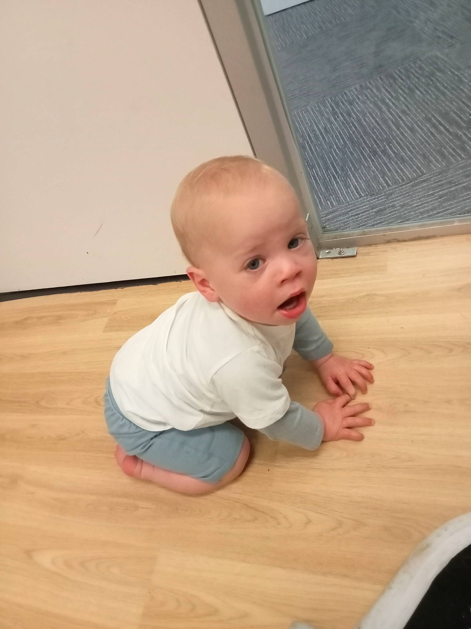 Aj is registered to the contest to win money with this photo: baby, baby_toddler_clothing, cheek, comfort, floor, flooring, foot, hardwood, knee, laminate_flooring, person, plywood, sitting, skin, sleeve, surprise, thumb, toddler, varnish, wood