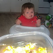 Allen joined the competition — help win amazing prizes! toddler, child, high_chair, red_shirt, food_container, fork, kitchen, floor, oven, cabinet, toy, yoshi, person, indoor, expression, furniture, baby, curious, sitting, meal