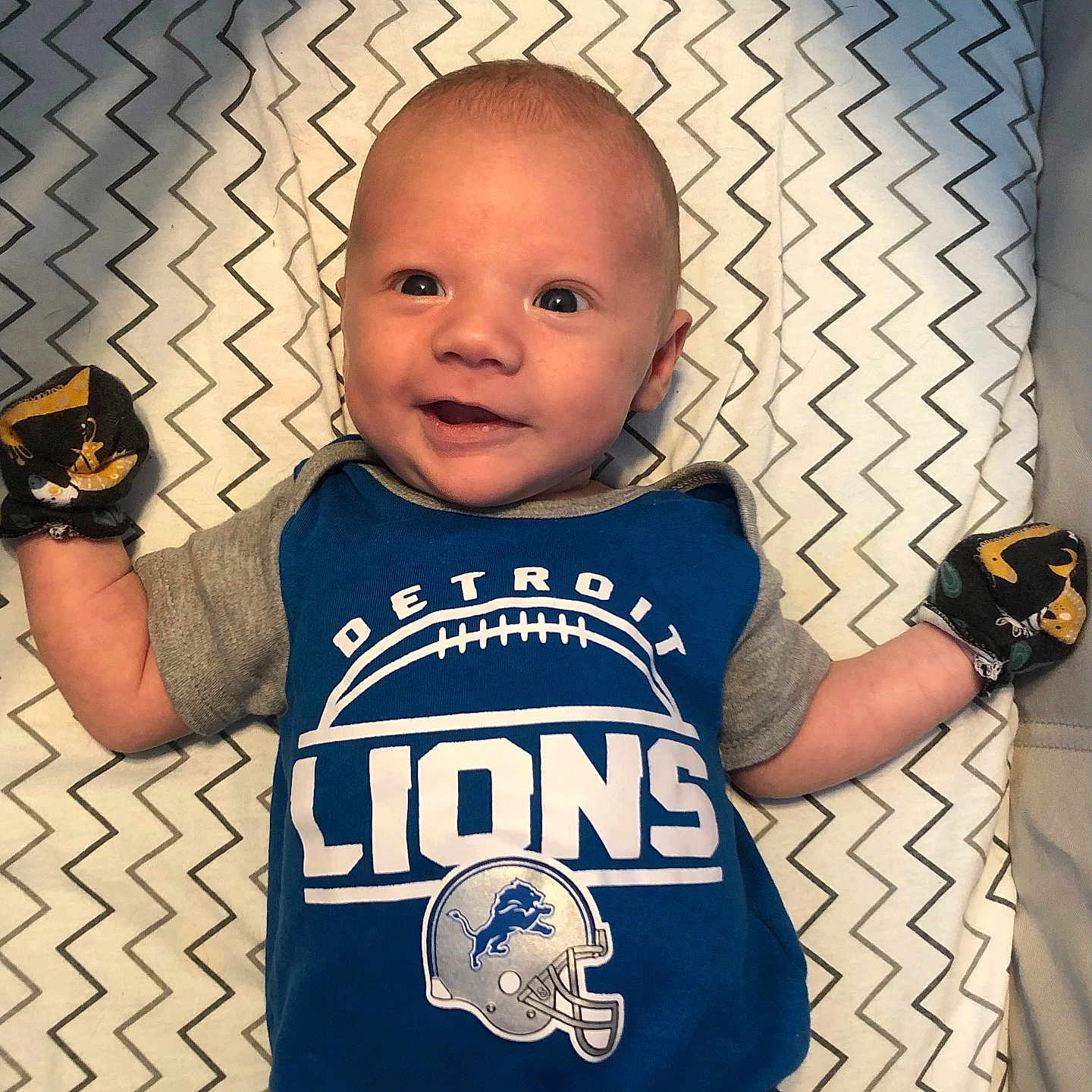 Tommy is registered to the contest to win money with this photo: arm, baby, baseball, baseballglove, bodypart, clothing, face, footwear, furniture, glove, head, pants, people, person, photography, portrait, shirt, shoe, sport, t_shirt