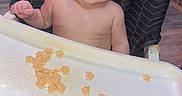 Skylar joined the competition — help win amazing prizes! baby, baby_food, bare_chest, barefoot, cereal, child, face, feeding, foot, furniture, hand, happy, high_chair, home, indoors, portrait, smiling, snacks, teeth, tray
