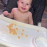 baby, child, high_chair, smiling, happy, portrait, indoors, feeding, snacks, cereal, tray, baby_food, bare_chest, barefoot, face, teeth, hand, foot, home, furniture