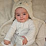 Rohan is registered to the contest to win money with this photo: baby, infant, child, face, hat, animal_hat, pajamas, blanket, soft_texture, cozy, cute, smiling, lying_down, indoors, portrait, young_child, warm, comfortable, skin, hand