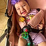 Kylie joined the competition — help win amazing prizes! baby, child, stroller, purple_flower, headband, smiling, happy, toy, pacifier, minnie_mouse, pink, clothing, seatbelt, infant, cute, indoors, floor_tiles, bracelet, person, portrait