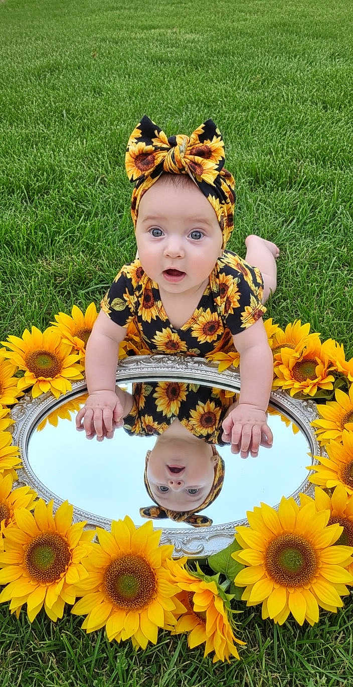 Kylie joined the competition — help win amazing prizes! baby, child, sunflower, headband, mirror, reflection, grass, outdoor, flower, green, nature, cute, infant, portrait, summer, bright, colorful, pattern, posing, happy