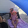 baby, child, pink_clothing, hat, beach, sand, umbrella, blanket, sunshade, outdoor, toddler, person, footwear, bag, relaxing, summer, vacation, shade, sitting, sun_protection