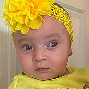Kylie joined the competition — help win amazing prizes! baby, child, yellow_headband, flower, mickey_mouse, minnie_mouse, yellow_shirt, earrings, face, portrait, cute, indoor, person, expression, apparel, headwear, young_child, looking_away, closeup, toddler