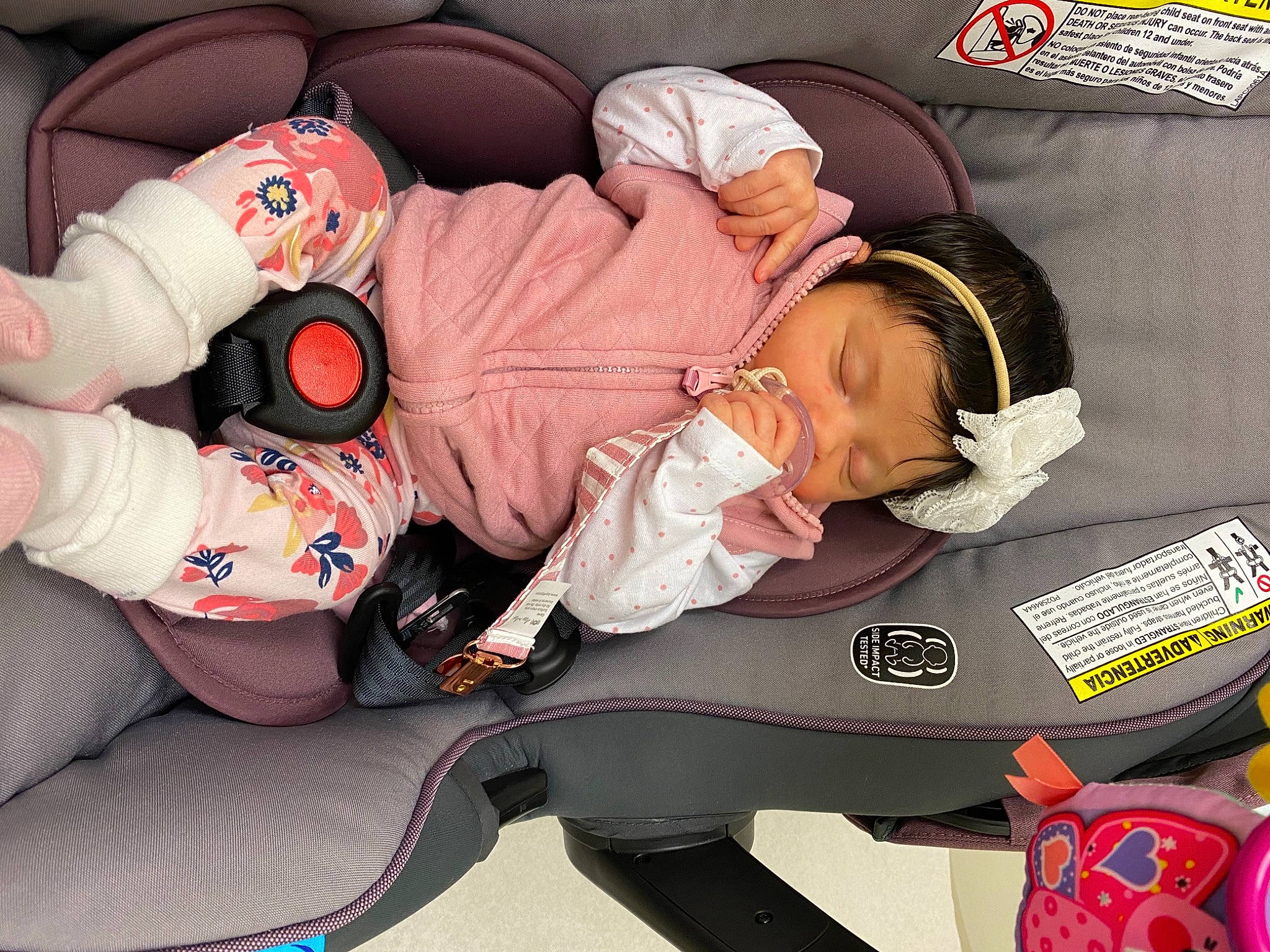 Fallon is registered to the contest to win money with this photo: auto_part, baby, baby_carriage, baby_in_car_seat, baby_products, baby_sleeping, baby_toddler_clothing, bag, car_seat, carmine, child, comfort, eyewear, headwear, lap, person, personal_protective_equipment, sitting, sleep, sunglasses