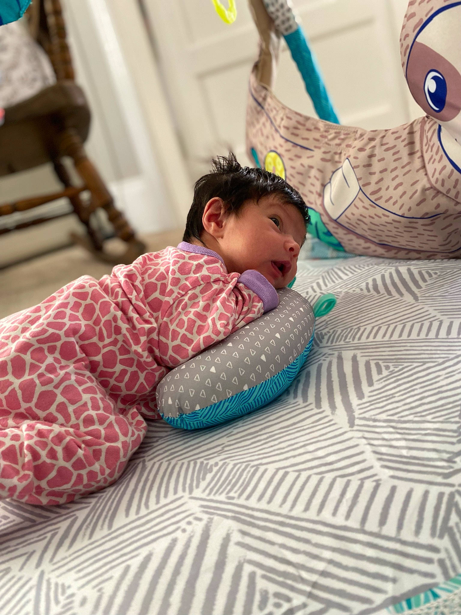 Fallon is registered to the contest to win money with this photo: baby, baby_products, baby_toddler_clothing, bed, blue, chair, child, comfort, face, flooring, fun, happy, leg, leisure, linens, person, sitting, skin, textile, toddler
