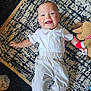Malakye joined the competition — help win amazing prizes! baby, barefoot, blue_eyes, child, collared_shirt, cute, happy, indoor, infant, lying_down, patterned_rug, person, plush_toy, reindeer, rug, shorts, smiling, striped_shorts, toy, white_shirt