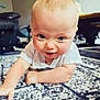 arm, baby, blue_eyes, carpet, child, clothing, crawling, curious, cute, face, head, home, indoor, infant, living_room, person, rug, skin, smiling, toddler